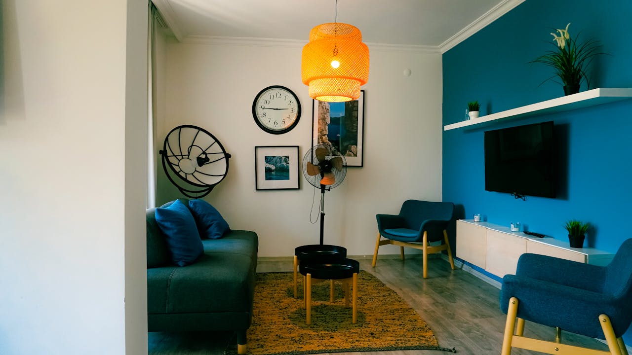 Stylish living room featuring contemporary furniture, blue accents, and a warm ambiance.