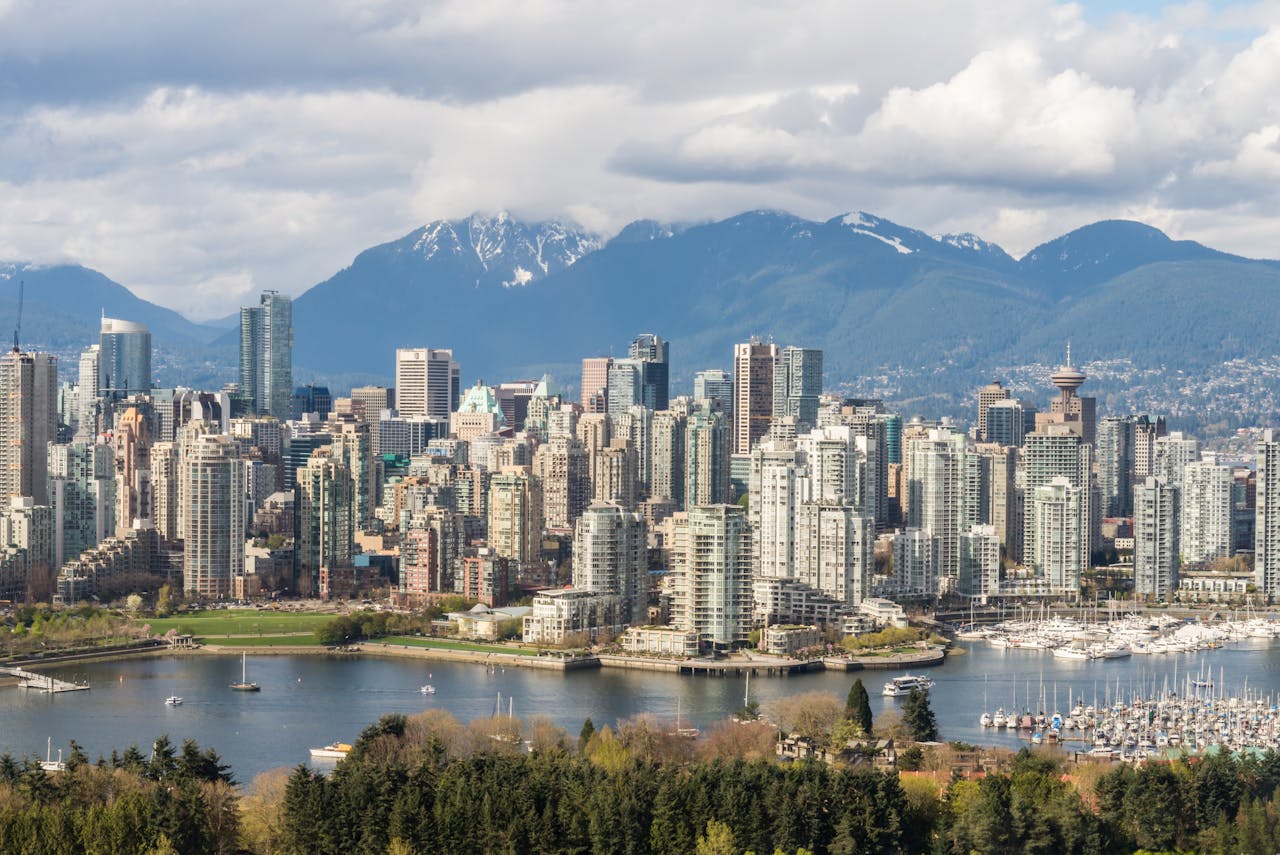 Services Stunning view of Vancouver's skyline with mountains and marina in the background.