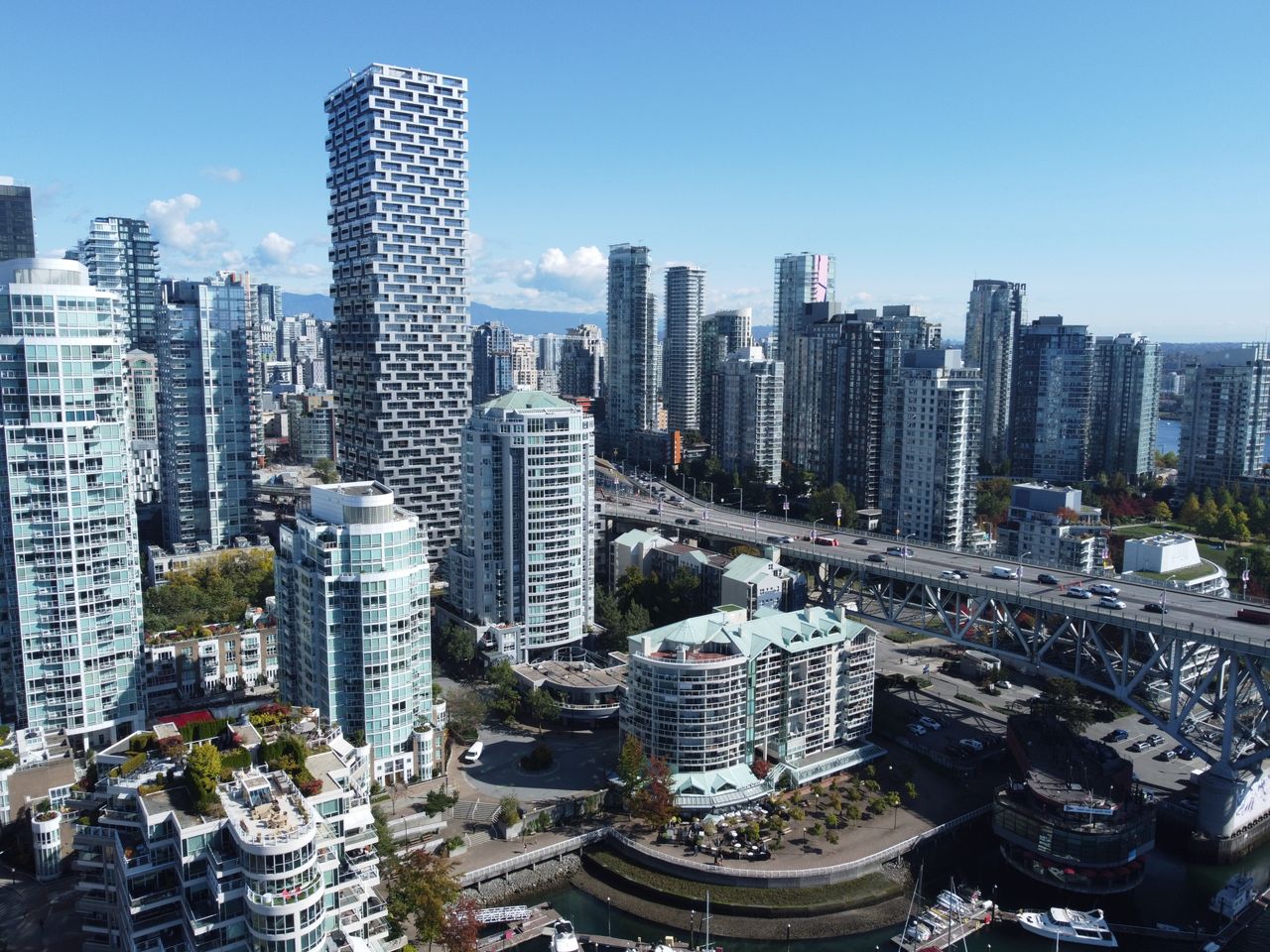 Services A stunning aerial view of Vancouver's skyline during daytime, showcasing modern architecture and bustling city life.